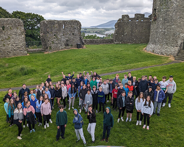 Students stood outside ruins