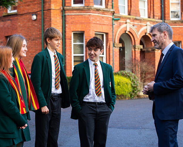 Principal talking to students outside