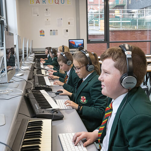 Students playing an electronic keyboard