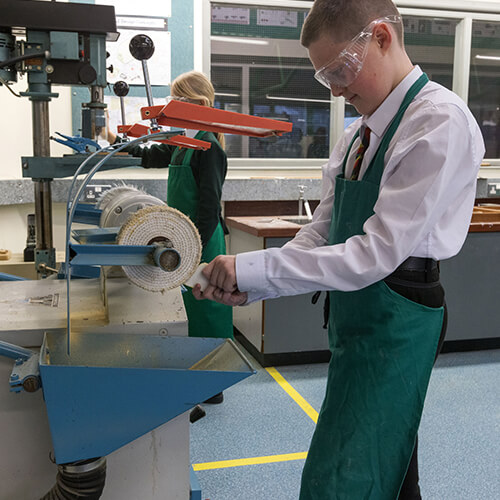 Student using a buffing machine