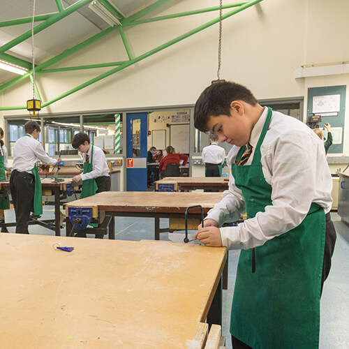 Student using a hand saw