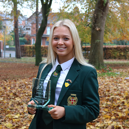 Student holding an award